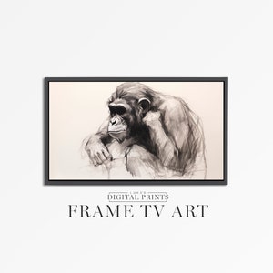 May include: Black and white drawing of a chimpanzee sitting with its chin resting on its hand. The drawing is framed in a black frame.