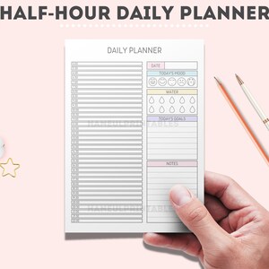 May include: A black and white daily planner with a half-hour time slot schedule. The planner includes sections for date, today's mood, water intake, today's goals, and notes.