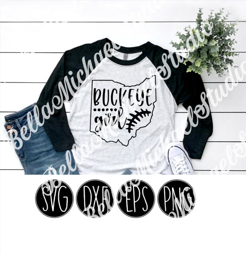 May include: A white and black baseball raglan t-shirt with the text "Buckeye girl" and an outline of the state of Ohio with a baseball stitch design. The shirt is on a white wooden surface with a pair of blue jeans and a potted plant. The image also includes four black circles with the text "SVG", "DXF", "EPS", and "PNG" in white.
