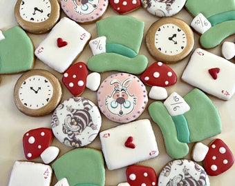 May include: Assortment of colorful, decorated sugar cookies featuring Alice in Wonderland characters, playing cards, and whimsical designs. The cookies are decorated with royal icing and have a variety of shapes and sizes.