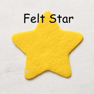 May include: A yellow felt star. Felt Star.