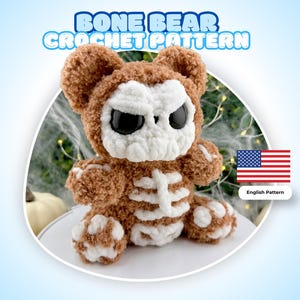 May include: A plush crochet bear toy featuring a brown fuzzy body with a white skull face, large black eyes, and a white ribcage design on the chest. The text BONE BEAR CROCHET PATTERN is displayed above the toy, with a small US flag icon nearby.