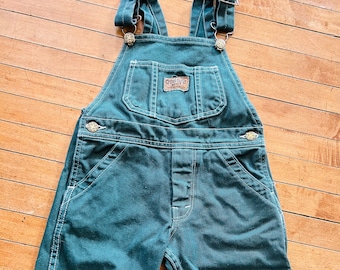 Vintage children’s size 2T Oshkosh B’Gosh green overalls.