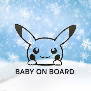 May include: A blue and white car decal featuring a cartoon character with large ears and the text "BABY ON BOARD". The design is set against a snowy background with snowflakes.