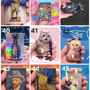 May include: A collection of rectangular cards featuring various designs. One card displays a gold trophy, another a colorful psychedelic pattern, and others showcase images of a cat, a painting, and a puppy. Each card has a gold chip.