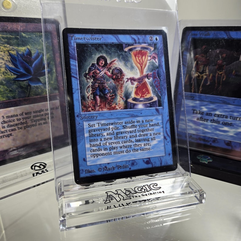 May include: A blue Magic: The Gathering card with the text "Timetwister" and the number "2" in the upper right corner. The card is a sorcery and reads "Set Timetwister aside in a new graveyard pile. Shuffle your hand, library, and graveyard together into a new library and draw a new hand of seven cards, leaving all cards in play where they are; opponent must do the same."