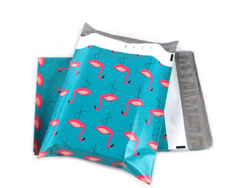 May include: Several turquoise poly mailer shipping envelopes with a repeating pattern of pink flamingos. The envelopes are sealed and ready for use. The background is white.