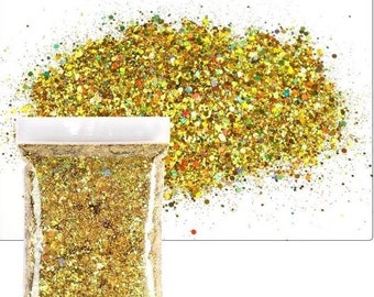 May include: A clear plastic bag filled with gold glitter. The glitter is a mix of different sizes and shapes, with some iridescent pieces. The bag is sitting on a white background.