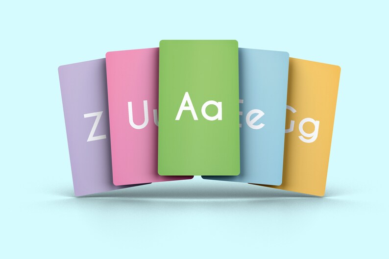 May include: Five colorful cards with letters of the alphabet printed on them. The cards are arranged in a semi-circle with the green card with the letters "Aa" in the center. The cards are purple, pink, green, blue, and yellow.