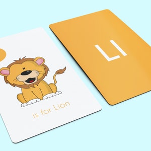 May include: A white card with a yellow circle containing the letter "L" and the word "Lion" written below. A cartoon lion is pictured on the card. The back of the card is yellow with the letter "L" in white.