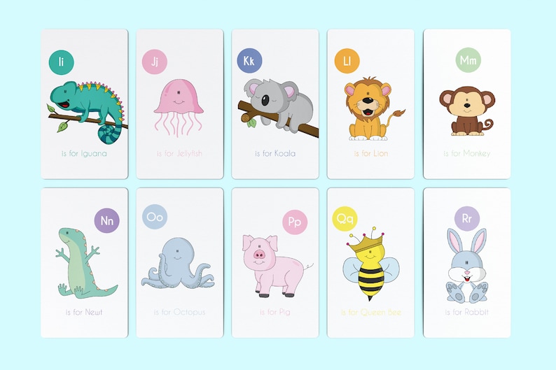 May include: A set of 10 alphabet flashcards featuring colorful illustrations of animals and the letter they represent. Each card has a different animal, such as an iguana, jellyfish, koala, lion, monkey, newt, octopus, pig, queen bee, and rabbit. The cards are designed for children learning the alphabet.