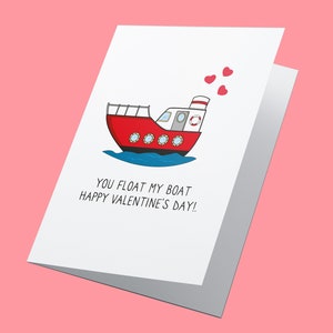 May include: A white card with a red boat illustration and the text "You float my boat Happy Valentine's Day!" with three red hearts above the boat.