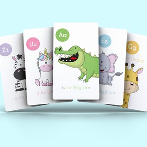 May include: Five colorful flashcards with letters of the alphabet and corresponding animals. The letters are Aa, Uu, Ee, Zz, and Gg. The animals are an alligator, a unicorn, an elephant, a zebra, and a giraffe.