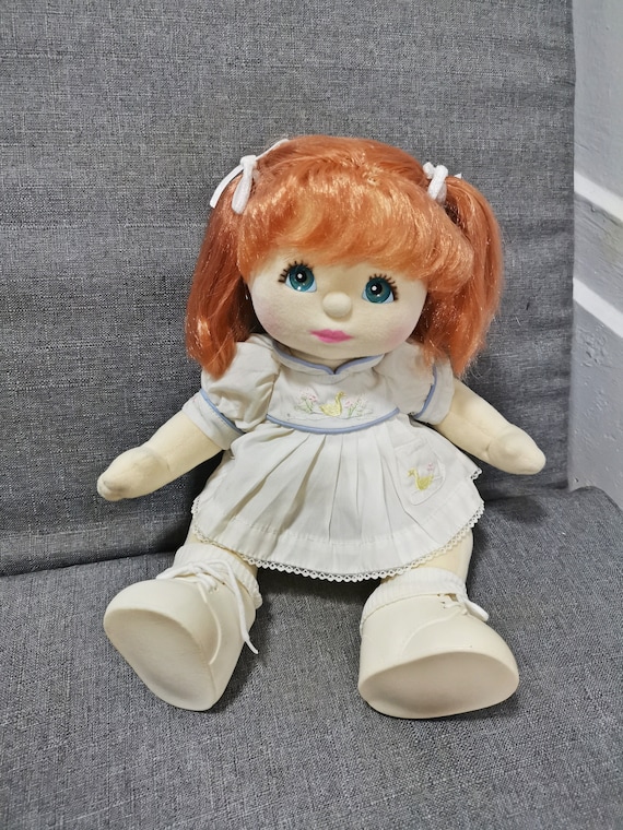 Baby doll with red sales hair and blue eyes