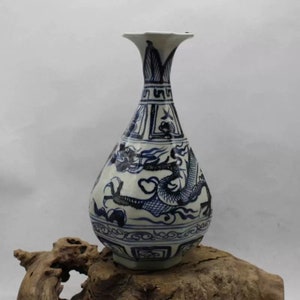 May include: A blue and white porcelain vase with a dragon design. The vase has a narrow neck and a wide, rounded body. The dragon is depicted in a swirling, dynamic pose.