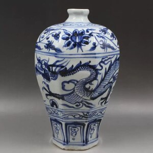 May include: A blue and white porcelain vase with a dragon design. The vase is octagonal in shape and has a flared mouth. The dragon is depicted in a dynamic pose, with its wings spread and its tail curled. The vase is decorated with floral motifs and geometric patterns.