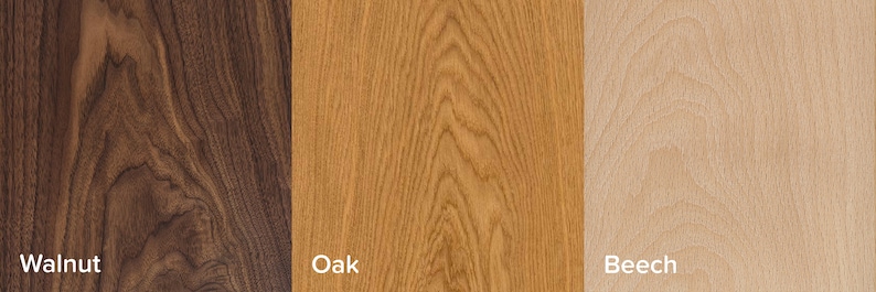 May include: Close-up of three wood samples: walnut, oak, and beech. The walnut sample is dark brown with a distinctive grain pattern. The oak sample is a light brown with a straight grain pattern. The beech sample is a light beige with a fine grain pattern.