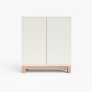 May include: A white cabinet with two doors and a wooden base. The cabinet has a simple, modern design.