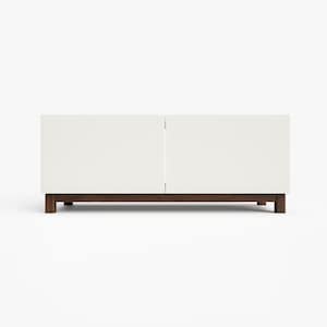 May include: A white media console with two doors and a wood base. The console has a modern design and is perfect for storing electronics and other media.