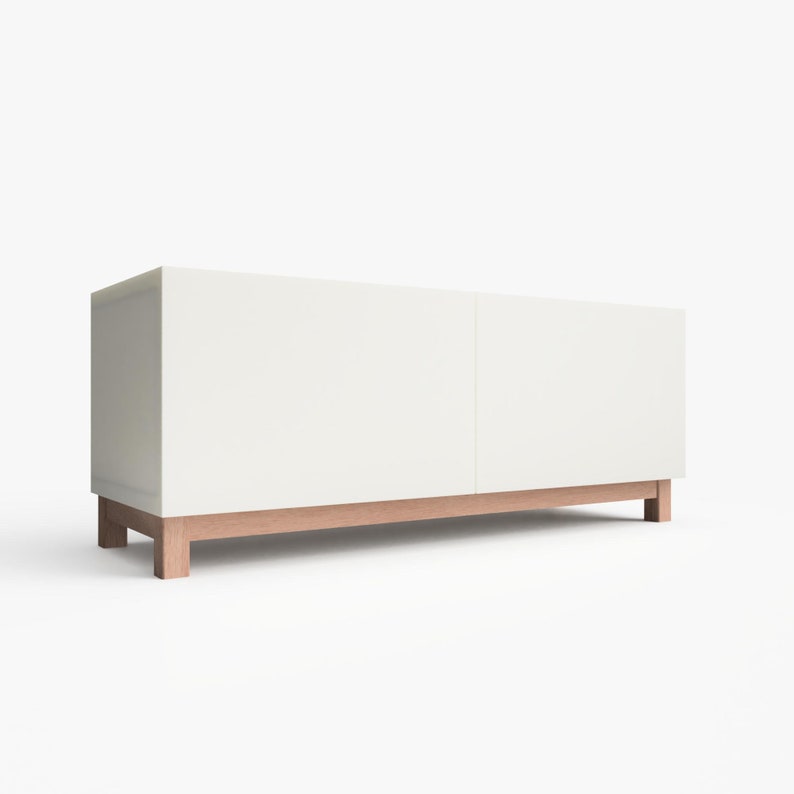 May include: White media console with two doors and a wood base. The console has a modern design and is perfect for storing electronics and other media.