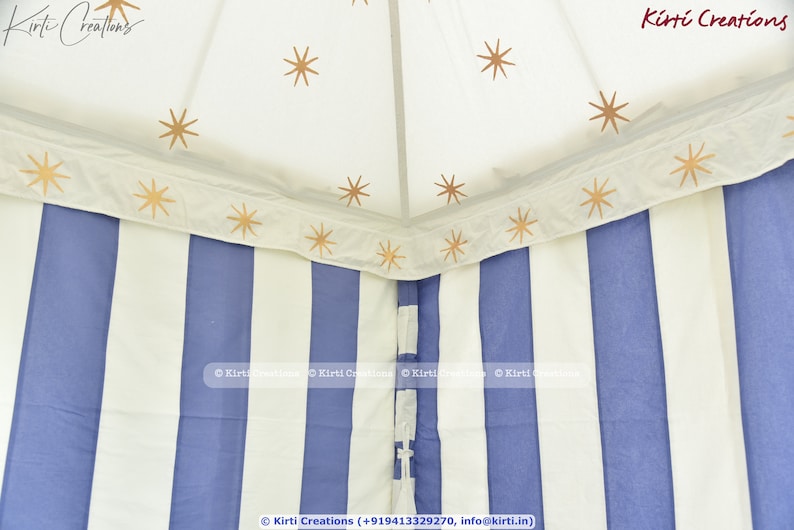 May include: A white and blue striped canopy tent with gold stars printed on the white fabric. The tent has a white fabric border with gold stars printed on it. The text "Kirti Creations" is printed on the fabric.