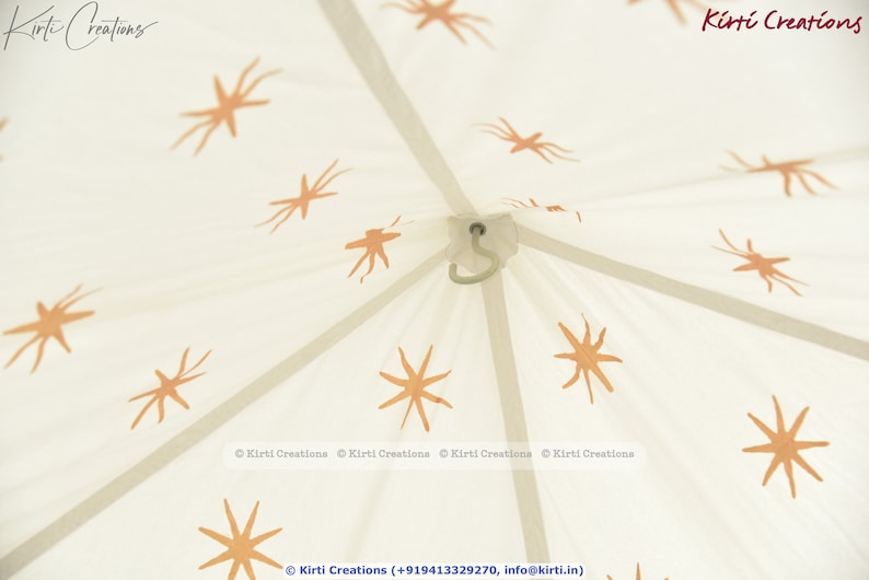 May include: White canvas tent with a star pattern printed on it. The tent has a hook at the top and is made of cotton.