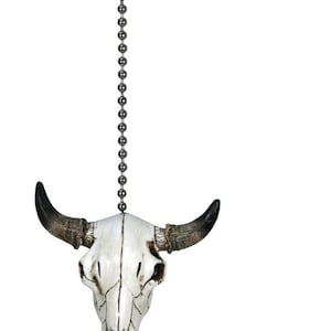 May include: White ceramic bull skull fan pull with black horns. The skull has a distressed finish and is attached to a silver chain.
