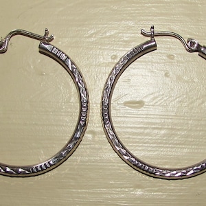 Pair of vintage Sterling Silver Hoops with Lazer cut designs. 1.5&quot;.