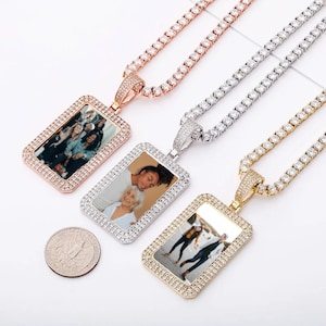 May include: Three gold, silver, and rose gold chains with a rectangular photo pendant. Each pendant is encrusted with clear cubic zirconia stones and features a different photo.