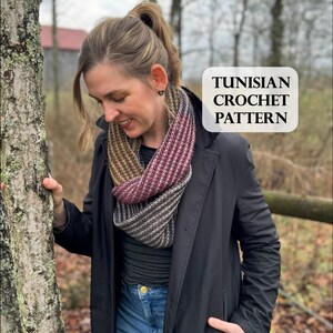 May include: A woman wearing a black coat and a colorful striped scarf. The scarf is made with a Tunisian crochet pattern. The text "Tunisian Crochet Pattern" is visible in the image.