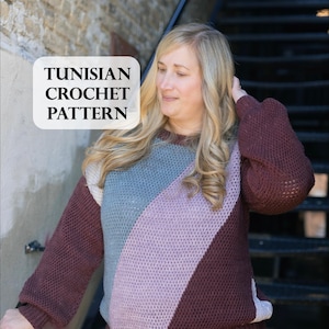 May include: A woman models a colour-blocked sweater, showcasing a Tunisian crochet pattern. The sweater has diagonal panels in burgundy, light blue, and lavender. The text "TUNISIAN CROCHET PATTERN" is in a white box.