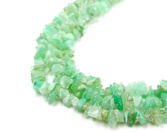 May include: A strand of green gemstone chips, likely jade or aventurine, strung together to form a necklace. The chips are irregular in shape and size, creating a natural and organic look.