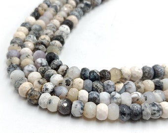 May include: A strand of white, gray, and black gemstone beads. The beads are faceted and have a speckled pattern.