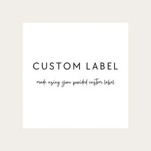 May include: A white square with the words "CUSTOM LABEL" in a bold, black, sans-serif font. Below, in a smaller, cursive font, it reads "made using your provided custom label."