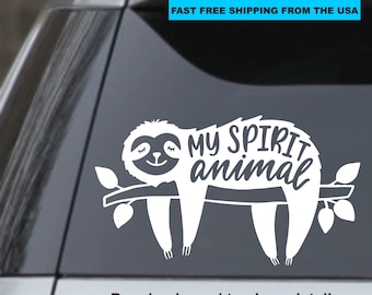 May include: White vinyl decal of a sloth hanging on a branch with the text "MY SPIRIT animal" in a white, stylized font.