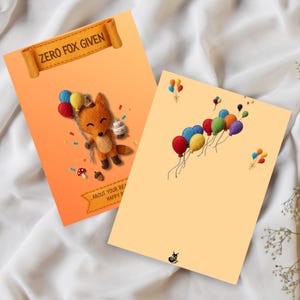 May include: Two rectangular greeting cards with orange backgrounds. The left card features a felt-style fox holding colorful balloons and a cake, with the text "ZERO FOX GIVEN" on a banner. The right card displays various colorful balloons and a small fox icon.