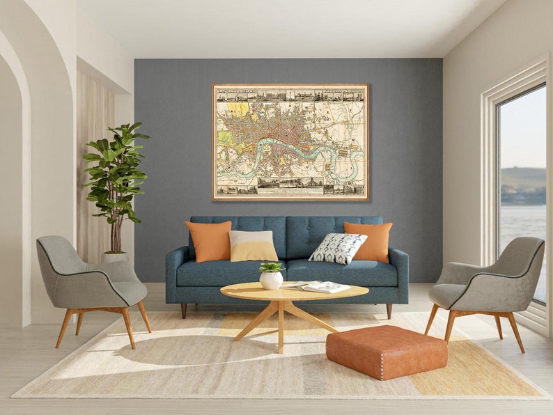 May include: A living room interior with a blue sofa, two gray chairs, a coffee table, and a large framed map of London on the wall. The room has a beige rug and a brown ottoman.