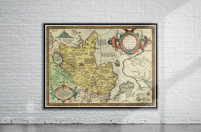 May include: An antique map of Tartaria, a vast region in northern Asia, with detailed borders and text in Latin. The map is framed in a gold-colored frame and has a decorative border with a compass rose and a coat of arms.