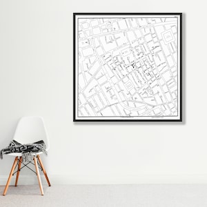 May include: Black and white map print of a city with street names and buildings. The map is framed in a black frame.