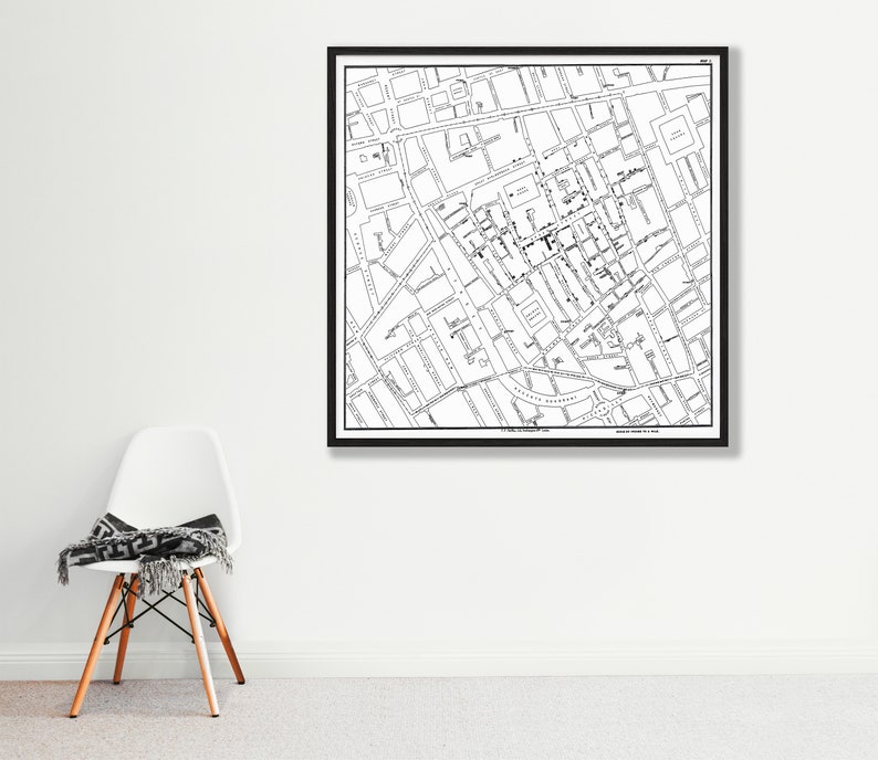 May include: Black and white map print of a city with street names and buildings. The map is framed in a black frame.