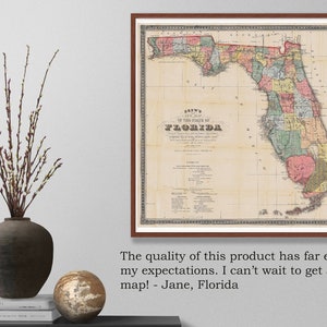 May include: A vintage map of the state of Florida, printed in color on paper. The map shows the counties of Florida and is framed in a brown wood frame.