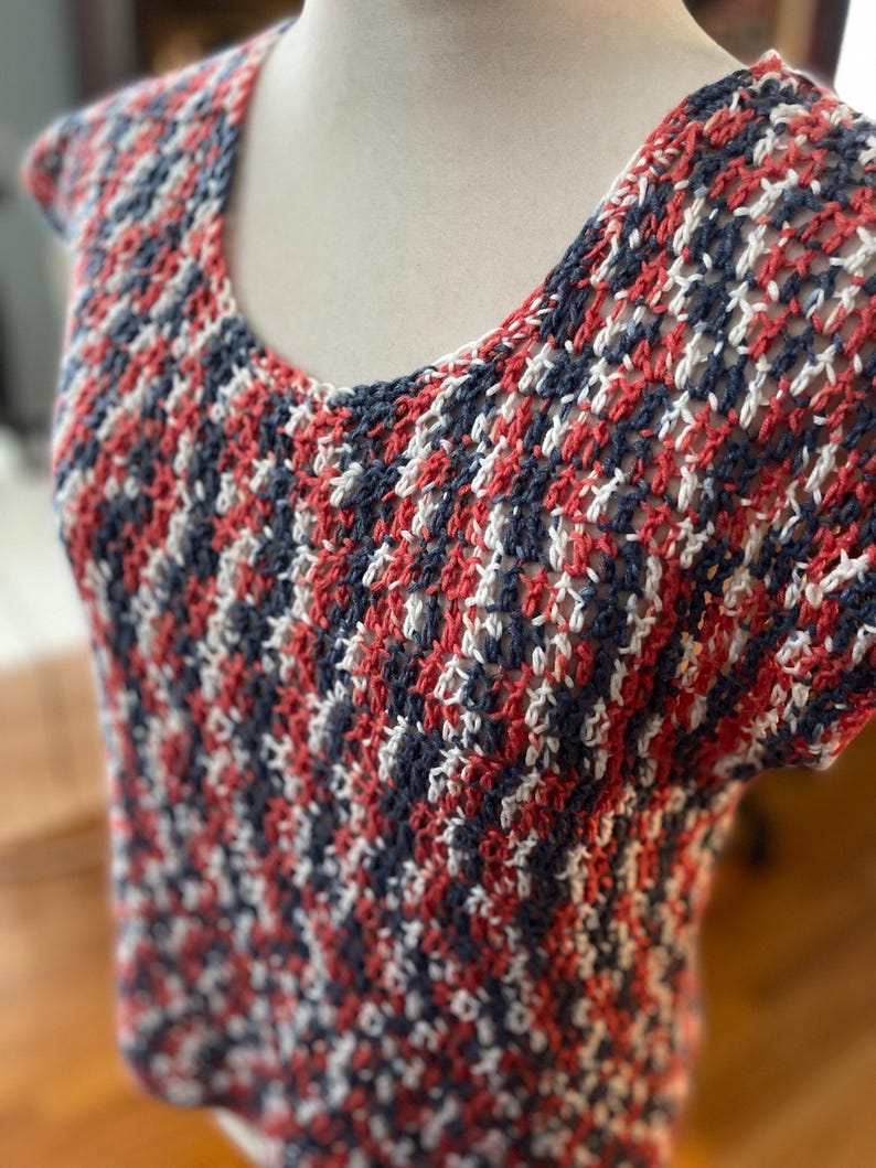 May include: A red, white and blue crocheted top with a loose, open weave.