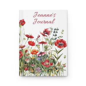 May include: A hardcover journal with a floral design featuring red poppies and other wildflowers. The title "Jeanne's Journal" is written in red script across the top. The cover is white.