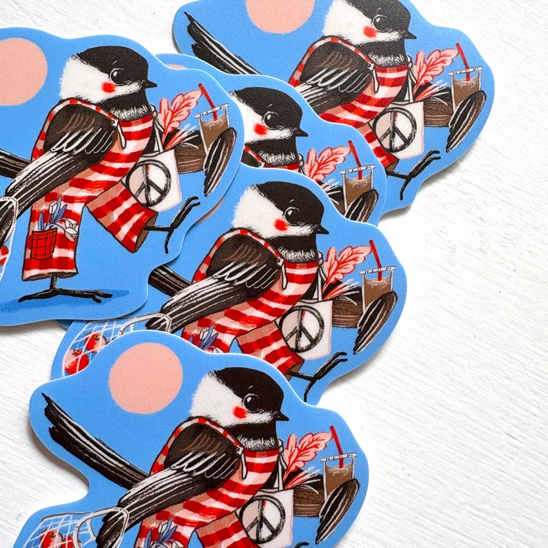 May include: A collection of die-cut stickers featuring a black-capped chickadee wearing a red and white striped scarf. The bird carries a white tote bag with a peace sign, a drink with a red straw, and a small mesh bag containing red items.