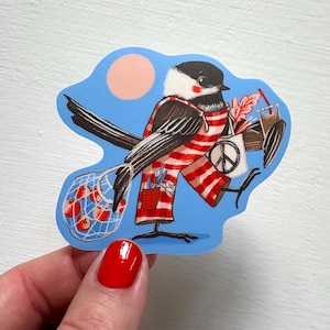 May include: A die-cut sticker featuring a black-capped chickadee wearing red and white striped overalls. The bird carries a mesh bag of red tomatoes, a white tote bag with a black peace sign, and a brown drink cup with a red straw against a blue background.