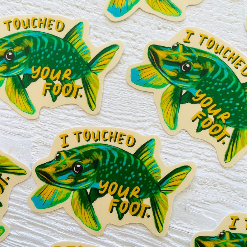 May include: Four stickers featuring a green and blue fish with the text "I Touched Your Foot." The fish has a yellow fin and a yellow tail.