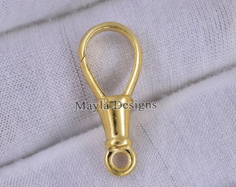 Pode incluir: Fecho giratório de metal dourado com um laço redondo. O fecho é projetado para ser preso a uma bolsa ou outro item.