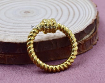 May include: A gold-colored ring with a twisted rope design and a knot at the top.