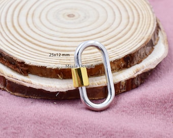 May include: Silver oval-shaped lobster clasp with a gold-colored barrel. The clasp measures 25x12 mm. The text "Mayla Designs" is visible on the clasp.