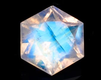 May include: A hexagonal, iridescent moonstone gemstone with a blue and white sheen.